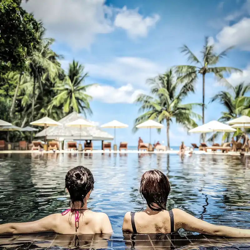 Ladies enjoying the pool overlooking the beach